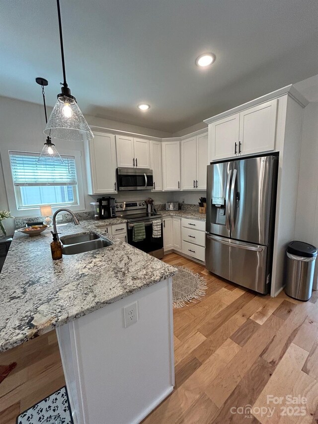 24 Wheeler Rd, Weaverville, NC 28787 - kitchen featuring stainless steel appliances, a sink, a peninsula, white cabinetry, and recessed lighting