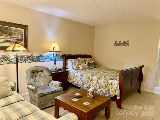 carpeted bedroom featuring a textured ceiling and baseboards