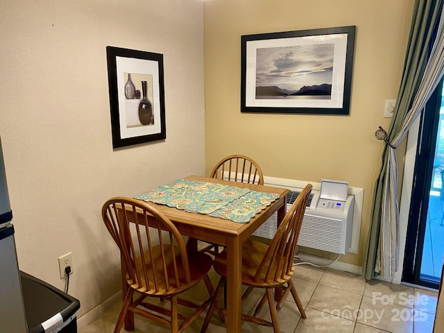 dining space featuring baseboards and light tile patterned floors