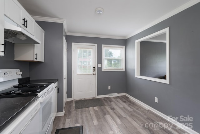 kitchen with crown molding, wood finished floors, white cabinets, under cabinet range hood, and white appliances