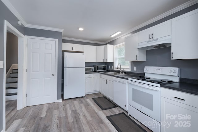 kitchen featuring dark countertops, white appliances, under cabinet range hood, white cabinets, and a sink