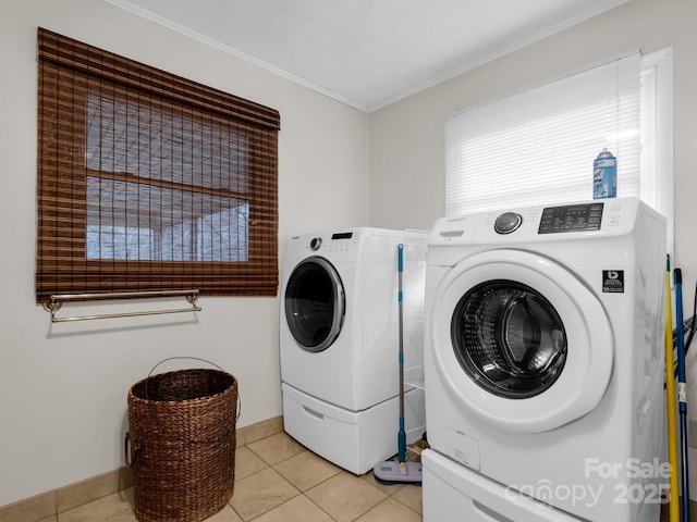 laundry area with laundry area, crown molding, baseboards, separate washer and dryer, and light tile patterned floors