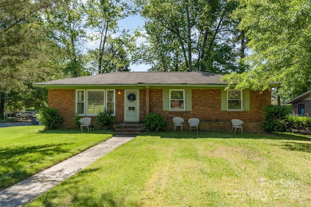 ranch-style house featuring brick siding and a front yard