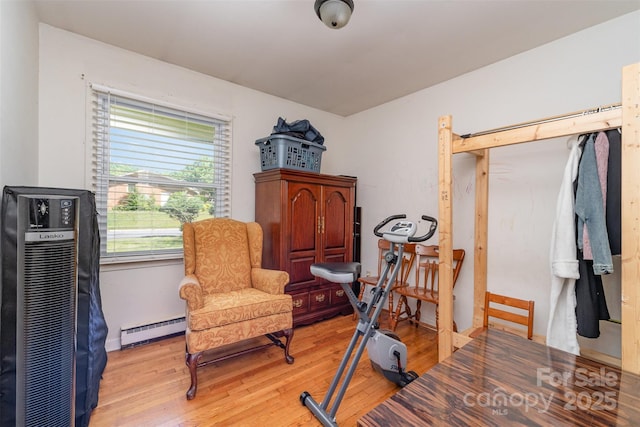 sitting room featuring a baseboard radiator and light wood-type flooring