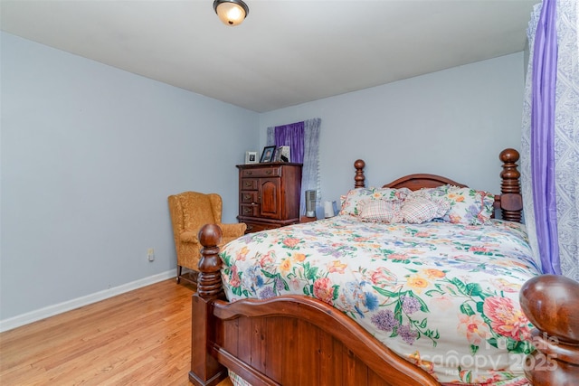bedroom with baseboards and light wood-style flooring