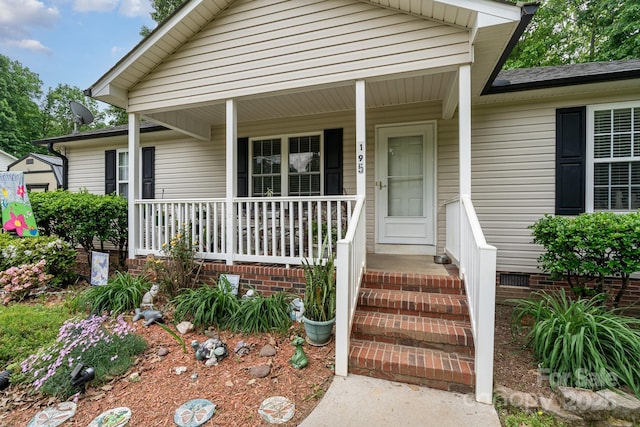entrance to property with a porch and crawl space