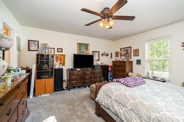 bedroom featuring light carpet and a ceiling fan