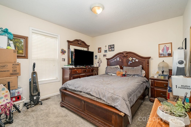 bedroom with baseboards and light carpet