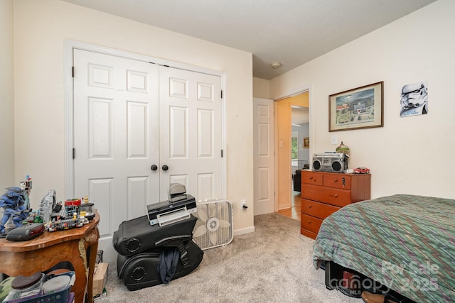 bedroom with a closet and light carpet