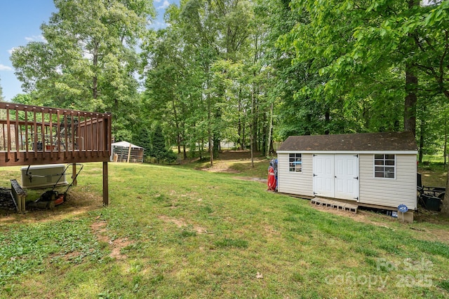 view of yard with a storage unit, an outdoor structure, and a deck