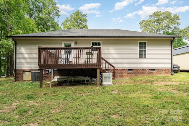rear view of house featuring a wooden deck, a yard, and crawl space