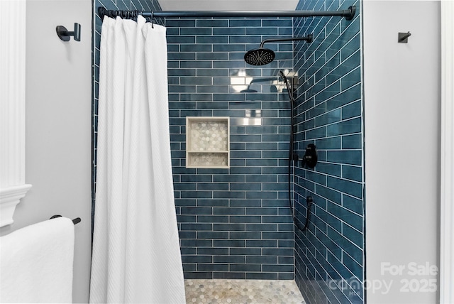 bathroom with toilet and a shower stall