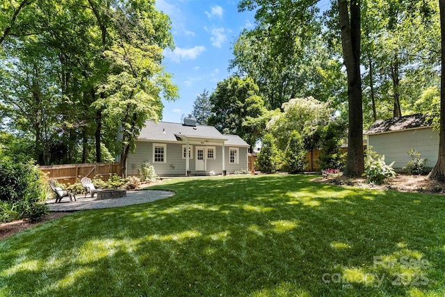 view of yard with a fenced backyard, an outdoor fire pit, and a patio area