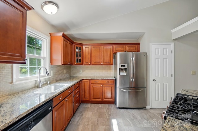 2379 Whitley Rd, Fort Mill, SC 29708 - kitchen featuring appliances with stainless steel finishes, a sink, vaulted ceiling, light stone counters, and backsplash