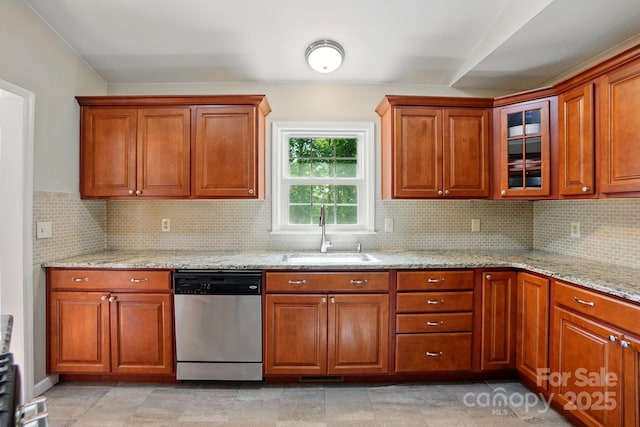 2379 Whitley Rd, Fort Mill, SC 29708 - kitchen with dishwasher, a sink, light stone counters, and brown cabinetry
