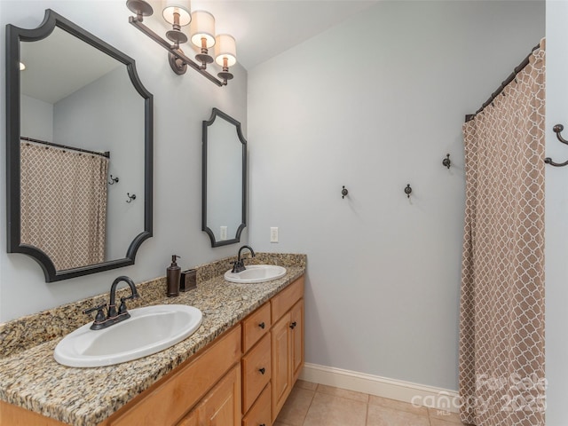 full bathroom featuring a sink, baseboards, tile patterned flooring, and double vanity