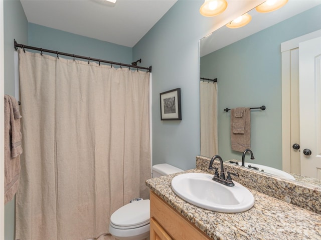 bathroom featuring toilet and vanity