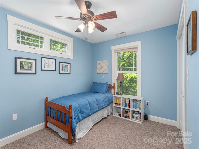 bedroom featuring a ceiling fan, baseboards, visible vents, and carpet