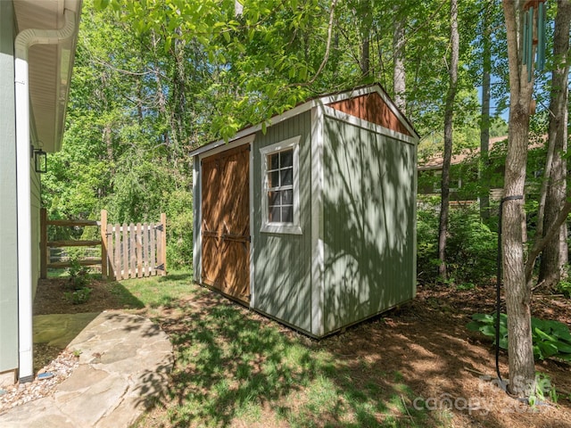 view of shed with fence