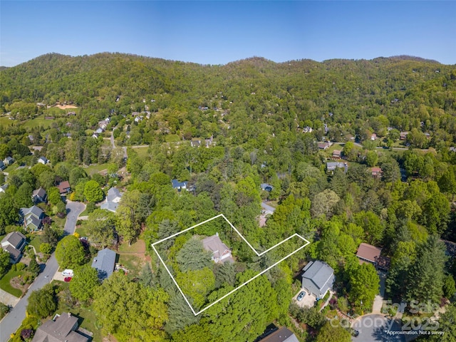 drone / aerial view featuring a wooded view