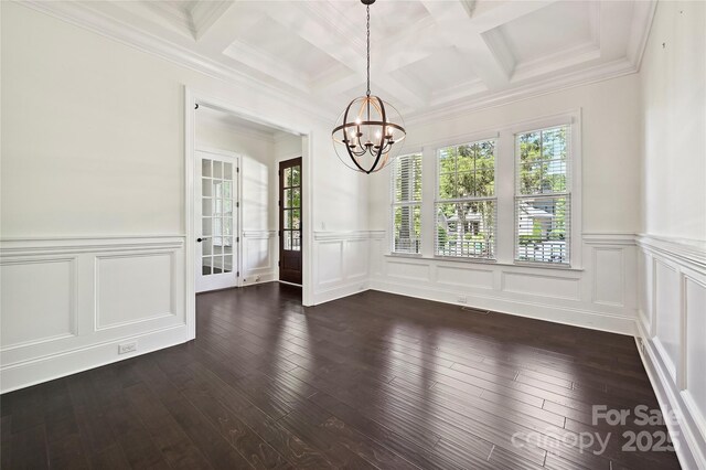 unfurnished dining area featuring an inviting chandelier, coffered ceiling, beam ceiling, and a wealth of natural light