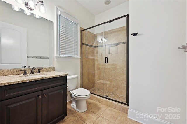 bathroom featuring toilet, a shower stall, tile patterned flooring, and vanity