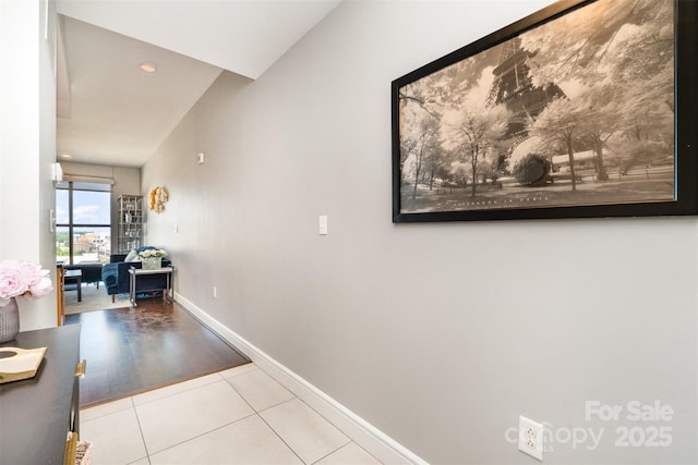 hallway with tile patterned flooring, recessed lighting, and baseboards