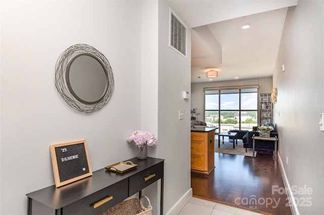 hallway featuring recessed lighting, baseboards, and visible vents