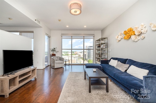 living area with recessed lighting and wood finished floors