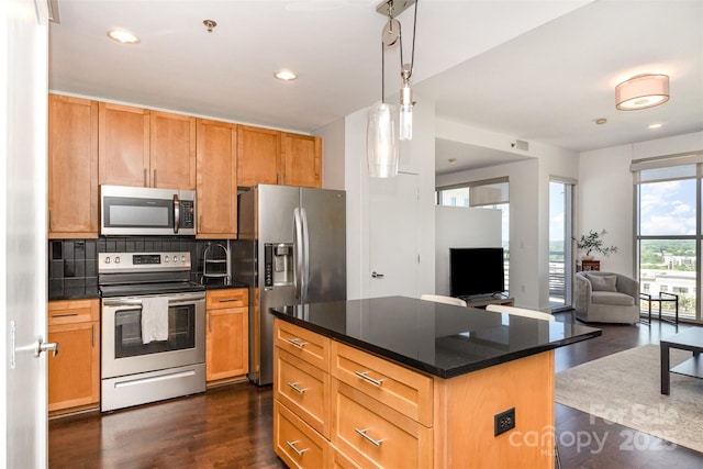 kitchen featuring dark countertops, stainless steel appliances, open floor plan, backsplash, and dark wood-style floors