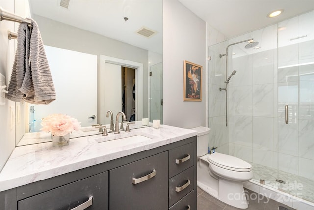 full bathroom with tile patterned flooring, vanity, toilet, a shower stall, and visible vents