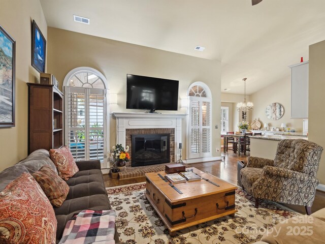 living area featuring visible vents, wood finished floors, and a wealth of natural light