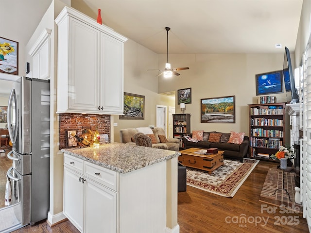 kitchen featuring freestanding refrigerator, a ceiling fan, white cabinets, and dark wood-style floors