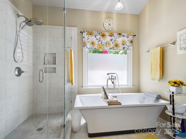 full bathroom with a freestanding tub, tile patterned floors, and a stall shower