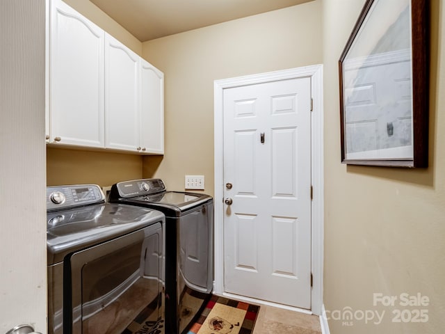 clothes washing area with cabinet space and separate washer and dryer