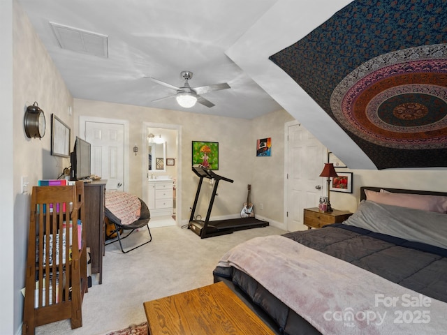 bedroom featuring ceiling fan, visible vents, baseboards, carpet, and ensuite bath