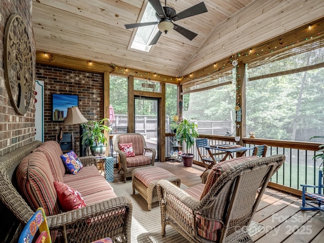 sunroom featuring a skylight, an outdoor living space, and a ceiling fan