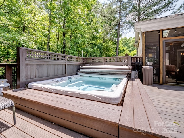 wooden terrace with a covered hot tub