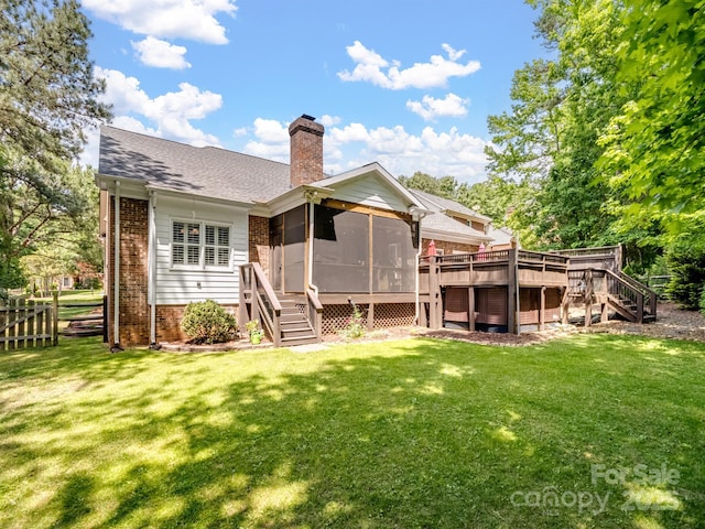 back of house with a wooden deck, a chimney, stairs, a sunroom, and brick siding