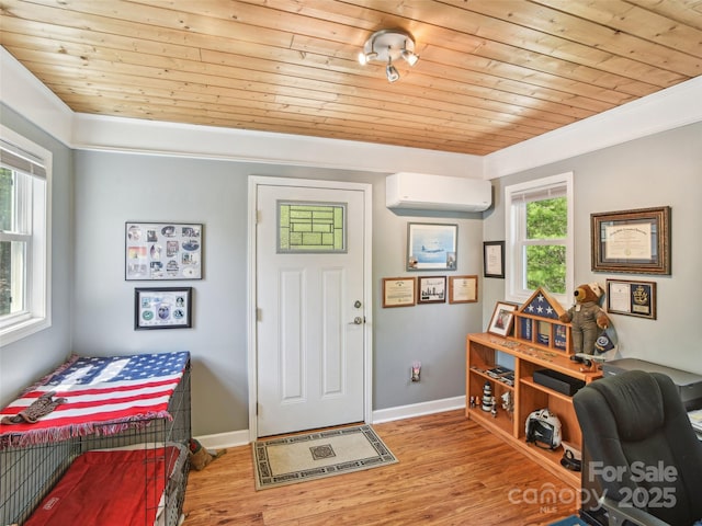 foyer entrance with crown molding, a wall mounted air conditioner, baseboards, wood finished floors, and wood ceiling