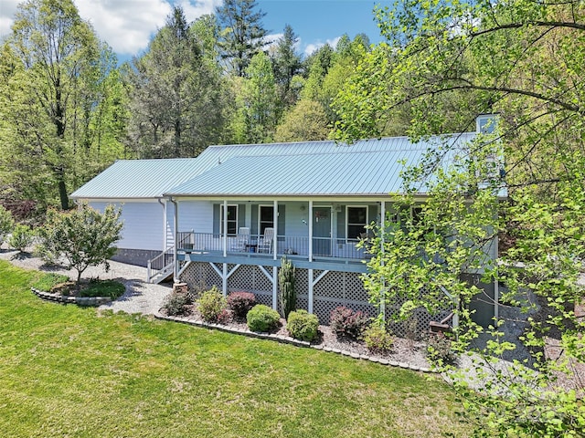 single story home with a porch, metal roof, and a front yard