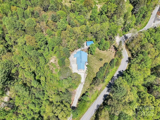birds eye view of property featuring a view of trees