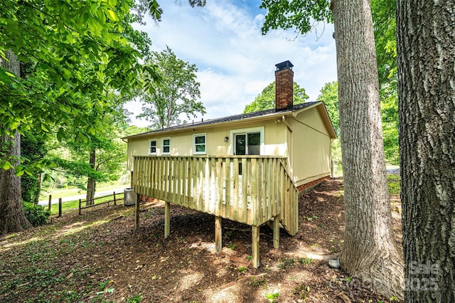 1018 Autumn Ln, Hickory, NC 28602 - rear view of property featuring central air condition unit, a wooden deck, a chimney, and fence