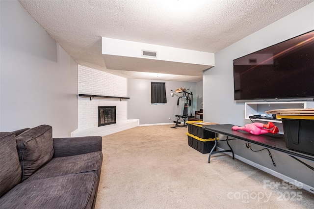 1018 Autumn Ln, Hickory, NC 28602 - carpeted living area with baseboards, a fireplace, a textured ceiling, and visible vents