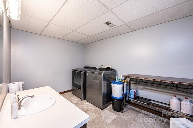 1018 Autumn Ln, Hickory, NC 28602 - clothes washing area featuring washing machine and clothes dryer, laundry area, visible vents, and a sink
