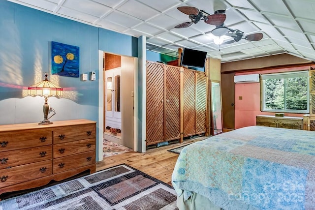 76 Archer Rd, Saluda, NC 28773 - bedroom with hardwood / wood-style flooring, a wall mounted air conditioner, and a ceiling fan