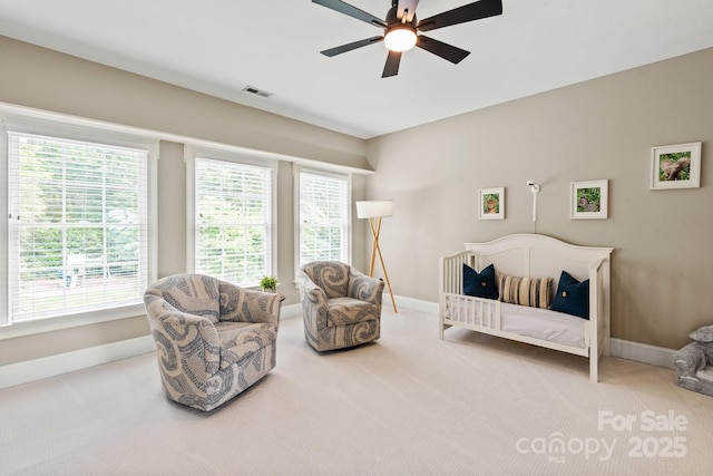 carpeted bedroom featuring a ceiling fan, baseboards, and visible vents