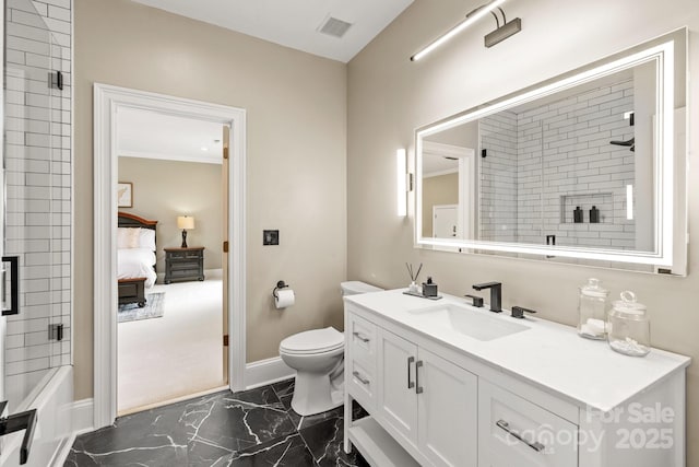 ensuite bathroom featuring vanity, toilet, marble finish floor, baseboards, and visible vents