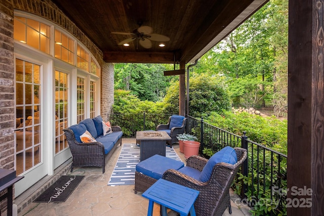 view of patio featuring an outdoor living space with a fire pit and ceiling fan