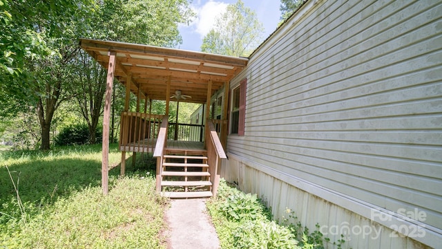 exterior space featuring a ceiling fan and a wooden deck